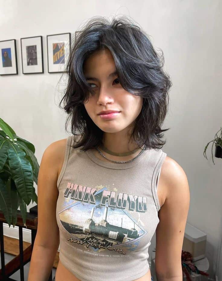 Young woman with layered, wavy short shag hairstyle for a modern look.